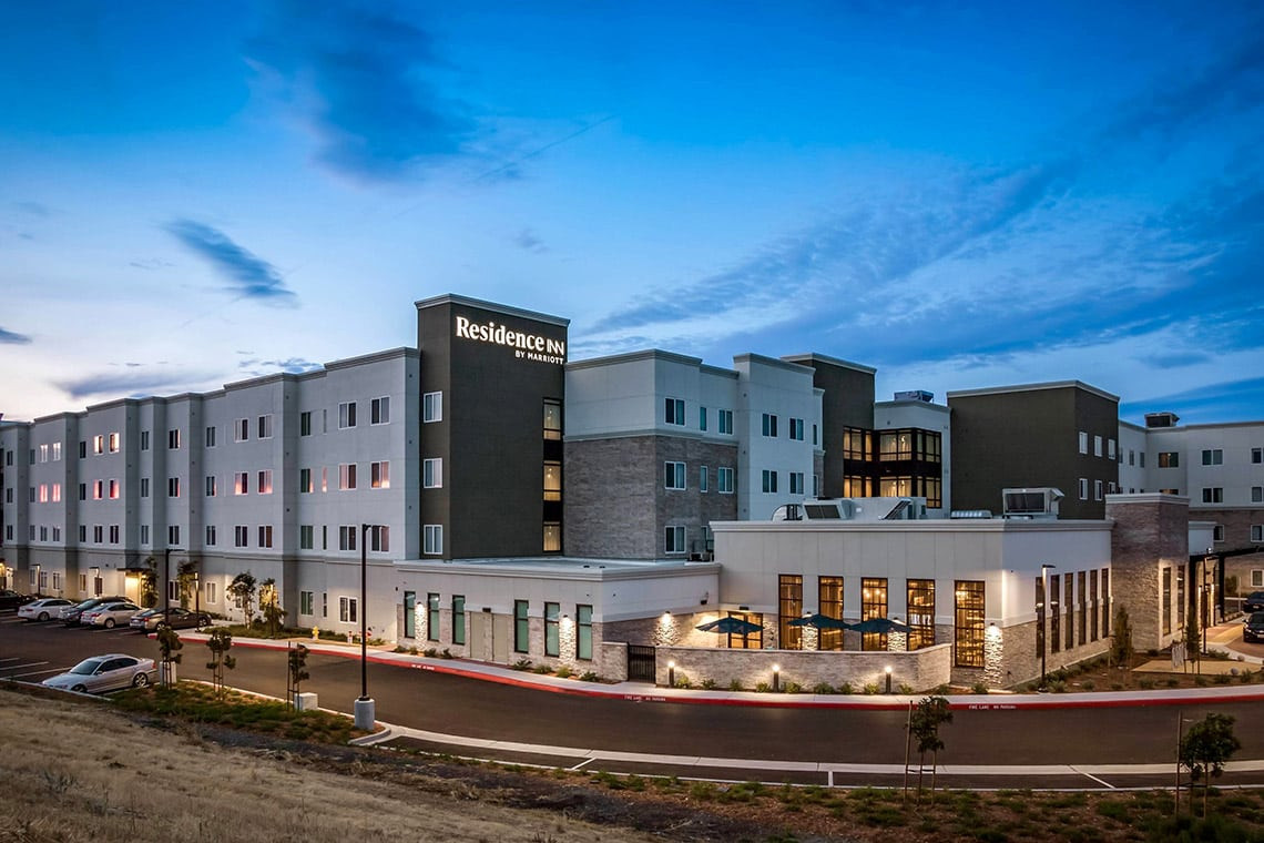 Exterior photo of the Residence Inn and Fairfield Inn Dual Branded Hotel in San Jose, CA during Twilight